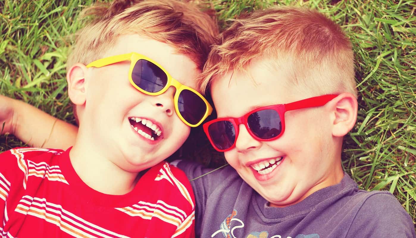 Happy boys with sunglasses enjoying the air